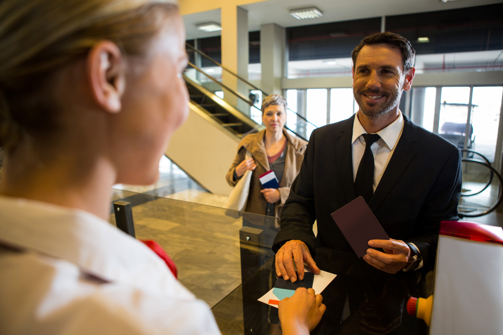 female-staff-giving-boarding-pass-passenger